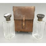 A pair of leather cased silver topped glass flasks