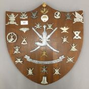A (Sultan of Oman) presentation shield of Omani military regimental cap badges