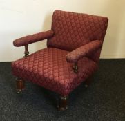 An early 19th century red upholstered armchair