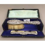 A cased silver brush and comb