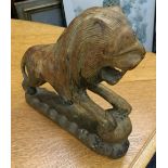 A carved wooden model of a lion