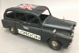 A tin plated model of a taxi