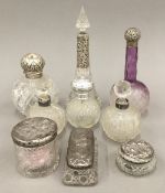 A collection of silver mounted cut glass scent bottles