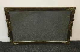 A mid-20th century brass framed mirror