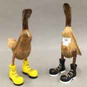 Two wooden ducks in boots