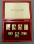 A cased set of silver gilt stamps