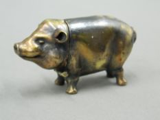 A brass vesta formed as a pig