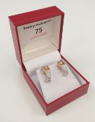 A pair of 18 ct yellow and white gold diamond earrings (4.
