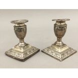 A pair of silver dwarf candlesticks (23.