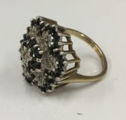 A 9 ct white gold diamond and sapphire cluster ring (4.