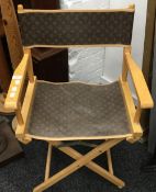 A folding director's chair decorated in the Louis Vuitton livery