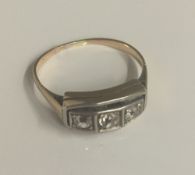 An unmarked gold three stone diamond ring (3.