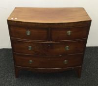 A George III mahogany bow front two over two chest of drawers