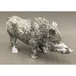 A silver coloured model of a wild boar