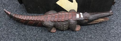 A large carved wooden model of a crocodile