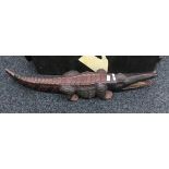 A large carved wooden model of a crocodile