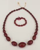 A cherry amber bead necklace and a matching bracelet (57.