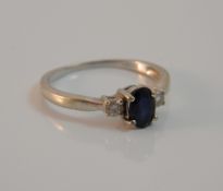 A 9 ct gold diamond and sapphire three stone ring (1.