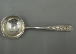 A Chinese silver spoon decorated with dragon and koi carp (18 grammes)