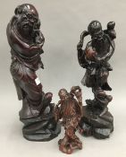 Three Chinese carved wooden figures of Shou Lao