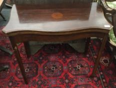 An early 20th century mahogany serpentine card table