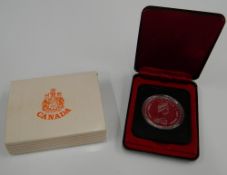 A boxed Canadian silver dollar
