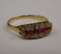 A gold diamond and ruby ring (3.