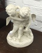 A Victorian Parian group formed as Cupid and an Amourini fighting over a heart