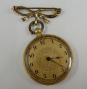 An 18 K gold ladies fob watch, on a 9 ct gold bow brooch (37.