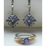 A pair of silver earrings and a silver ring