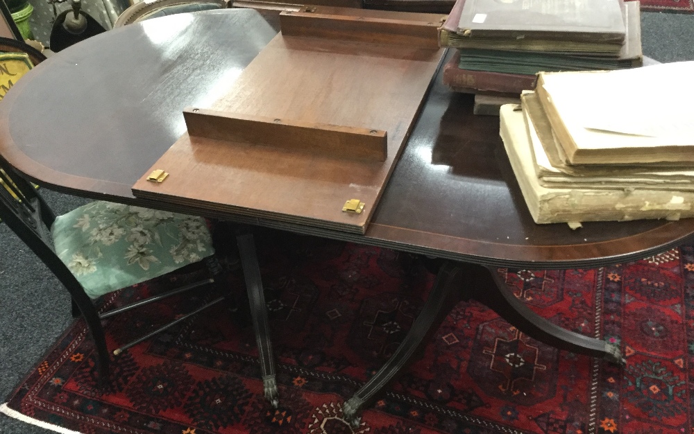 A reproduction pedestal dining table