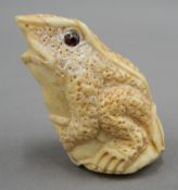 A bone carving of a frog