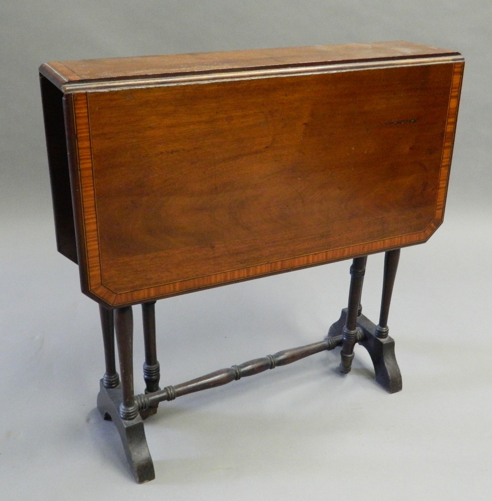 An Edwardian inlaid mahogany Sutherland table