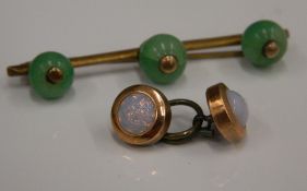 A jade and yellow metal brooch