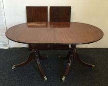 An 18th century style mahogany dining table. 99 cm wide, 74.5 cm high, 243 cm long.