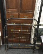 A Victorian brass and iron single bed