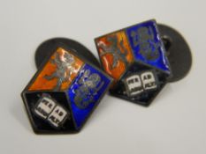 A pair of silver and enamel heraldic cufflinks