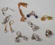 A box of various silver earrings and pendants