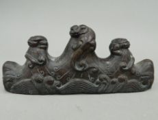 A Chinese carved wooden brush rest