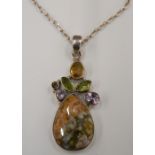 A multi-gem set silver pendant on chain