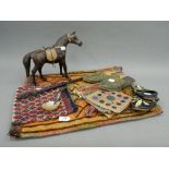 A collection of ethnographic items, including tapestry shoes, etc.