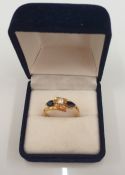 An 18 ct gold diamond and sapphire ring (3.