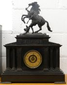 A Victorian black slate mantle clock surmounted with a Marley horse