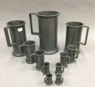 A quantity of pewter jugs