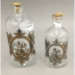 Two gilt decorated clear glass decanters