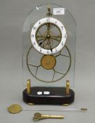 A glass fronted skeleton clock