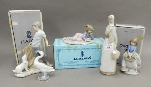 A boxed Lladro figurine, May Flowers; together with a Lladro Swan, another Lladro figurine,