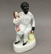 A Staffordshire porcelain figure of Uncle Tom and Ev (Eva)