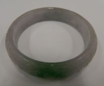 A carved jade bangle