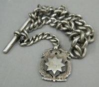 A silver Albert chain with fob